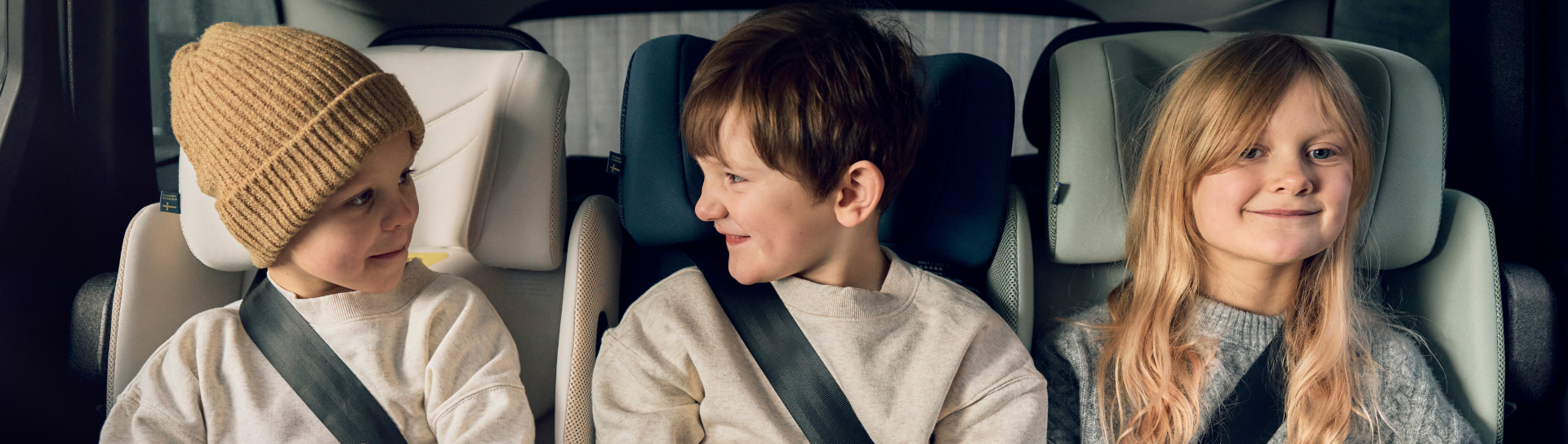 Three children in Axkid Up placed three in a row