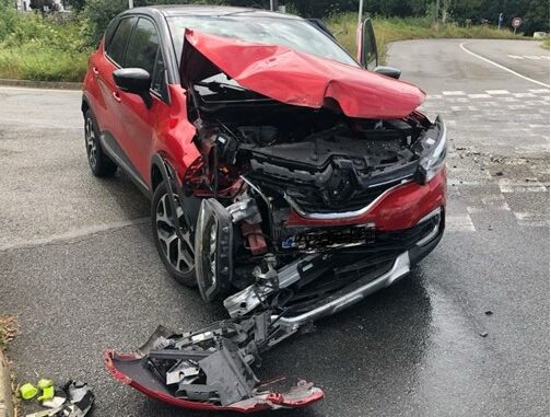 red car with front of car smashed in from a frontal crash