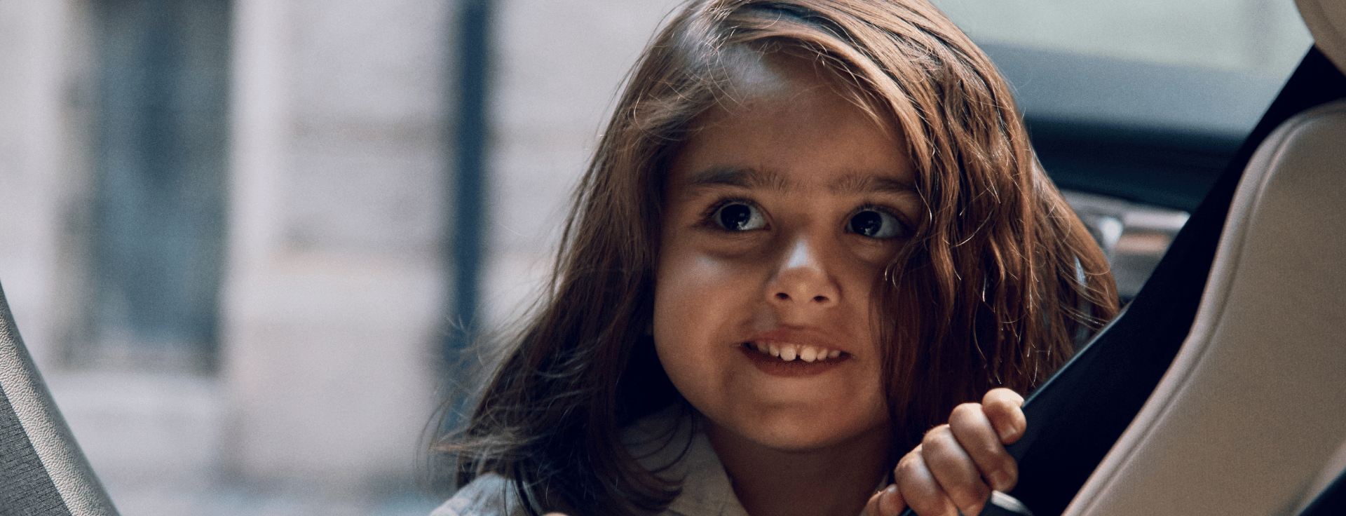 header lifestyle image child climbing in to car seat 1920x736